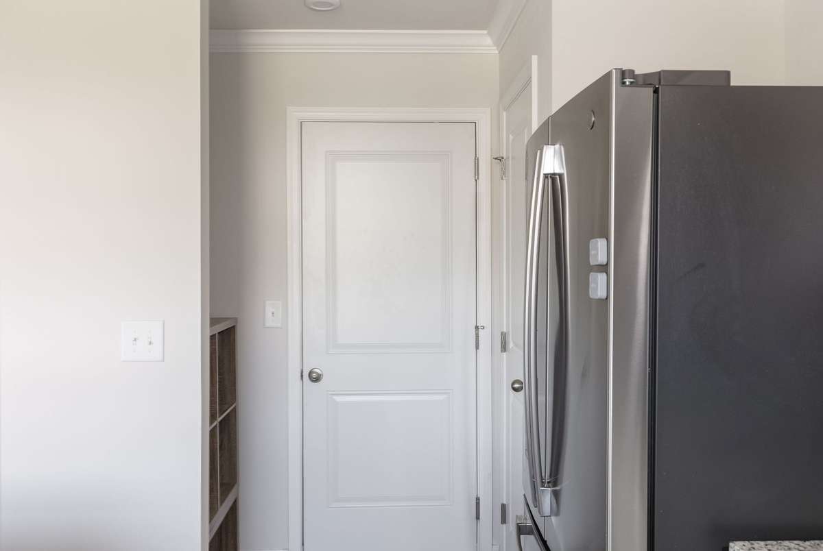 Drop zone area + additional coat closet is  tucked between kitchen & 2 car garage