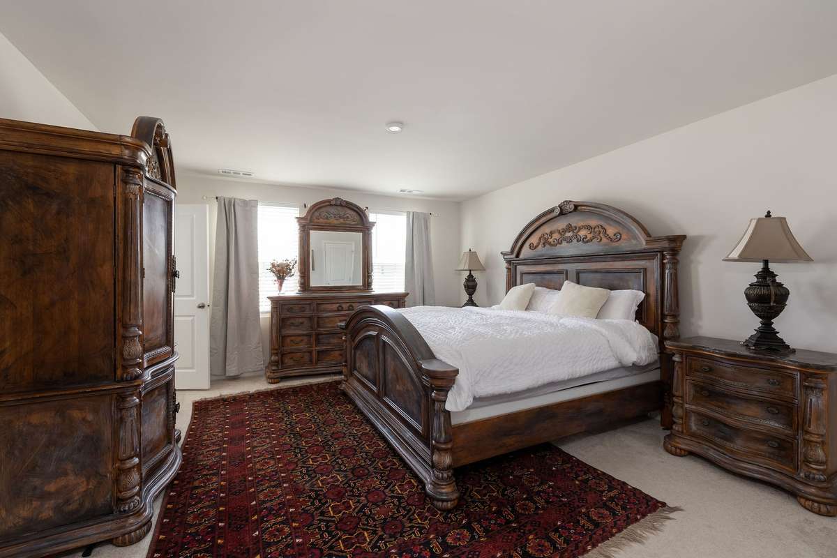 Primary bedroom located upstairs and features 2 walk in closets with an ensuite bathroom