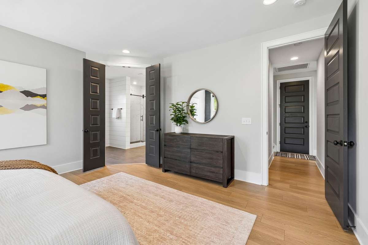 Double doors open to the primary bathroom