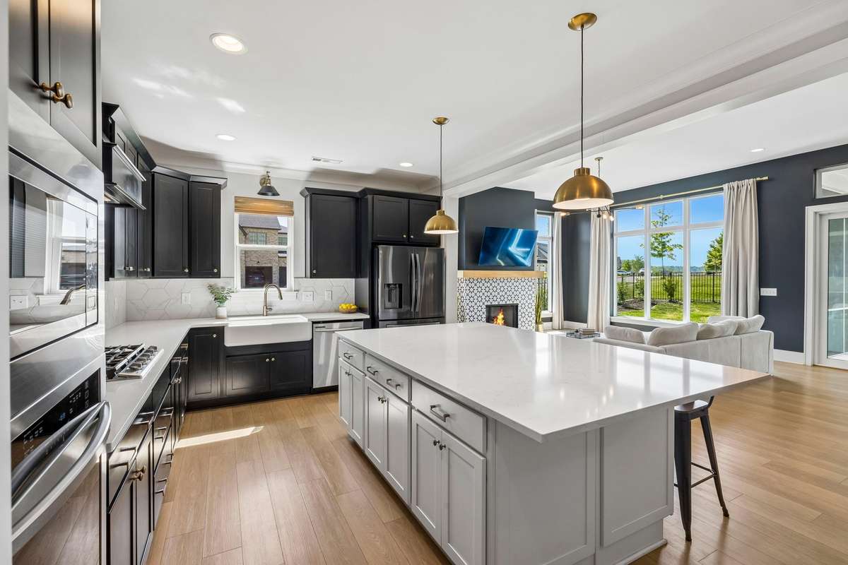 Absolutely beautiful designer kitchen with two-toned cabinets and an extended island
