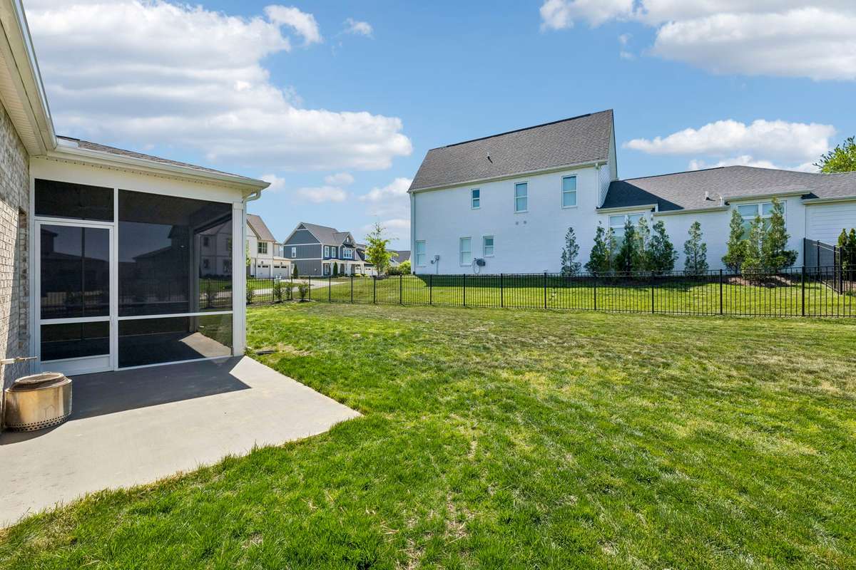 You will marvel at this truly massive yard with wrought iron fencing