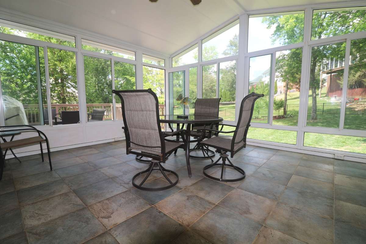 This wonderful sunroom connects to a nice deck & overlooks the fenced back yard.
