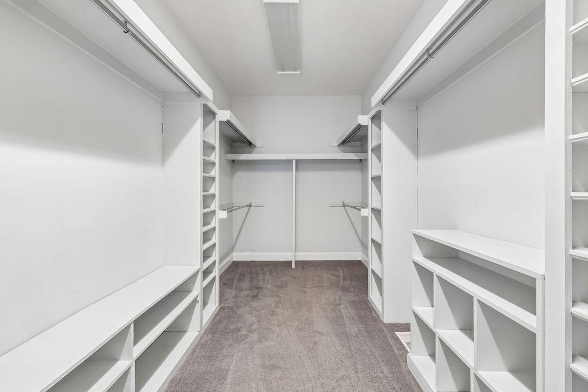 The primary closet is a large, walk-in with custom shelves.