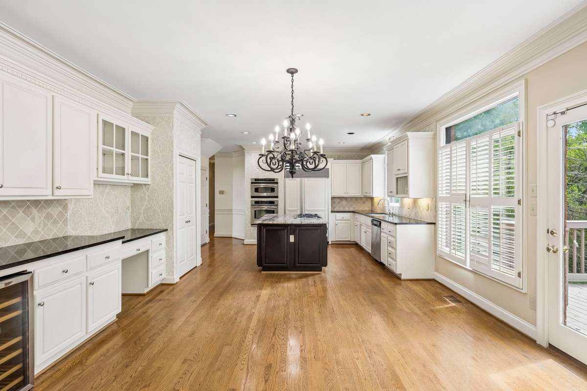 Plenty of space for an eat-in kitchen table including a beverage refrigerator and extra cabinet space.
