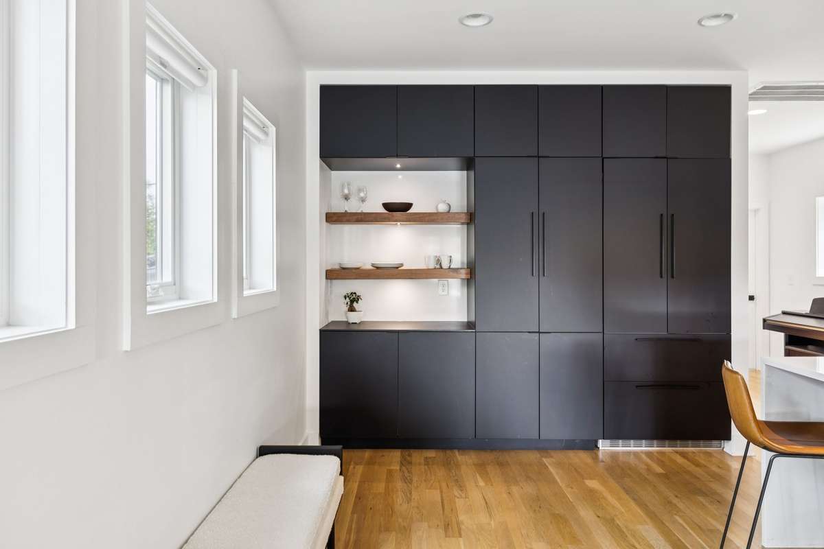 Pantry and Liebherr refrigerator behind the custom cabinetry.