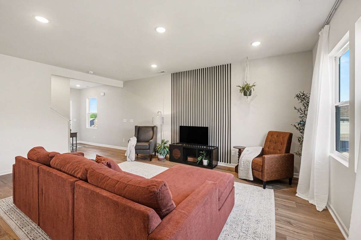 In this photo you can see there is a nice foyer, and the powder room is right off of that as well as the access to the stairs