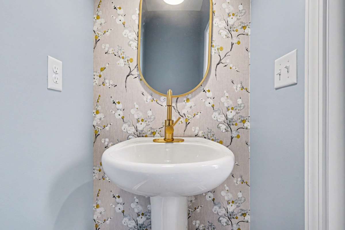 Powder room just off the front door, so your guests don't have to go upstairs. All bathroom faucets and lights have been updated!