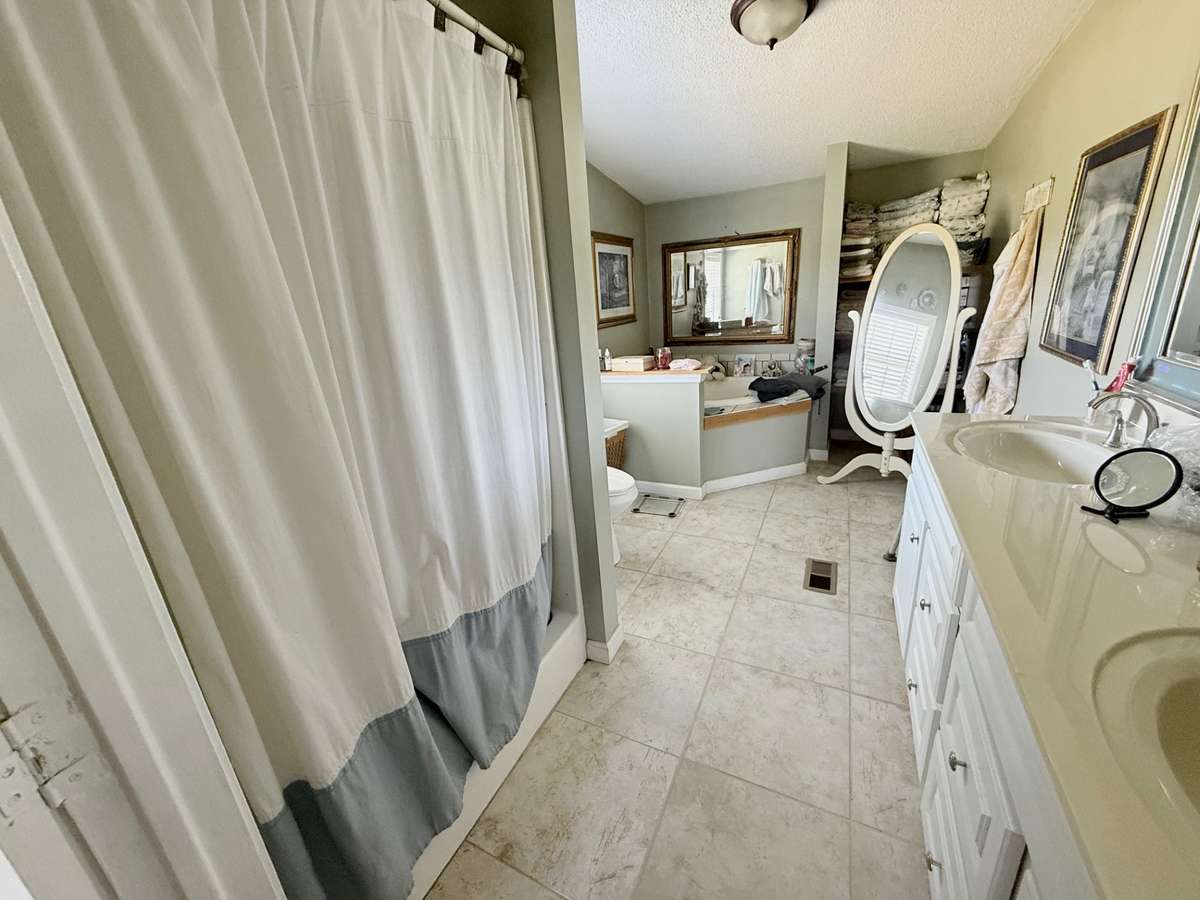 Master bath with shower and large tub. Tub never hooked up or used