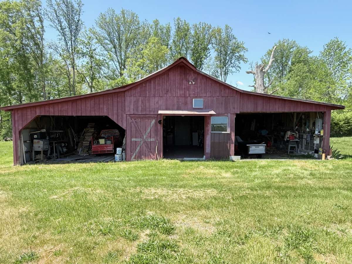 Large barn with several room and stalls along with loft. Has water and 220 electric
