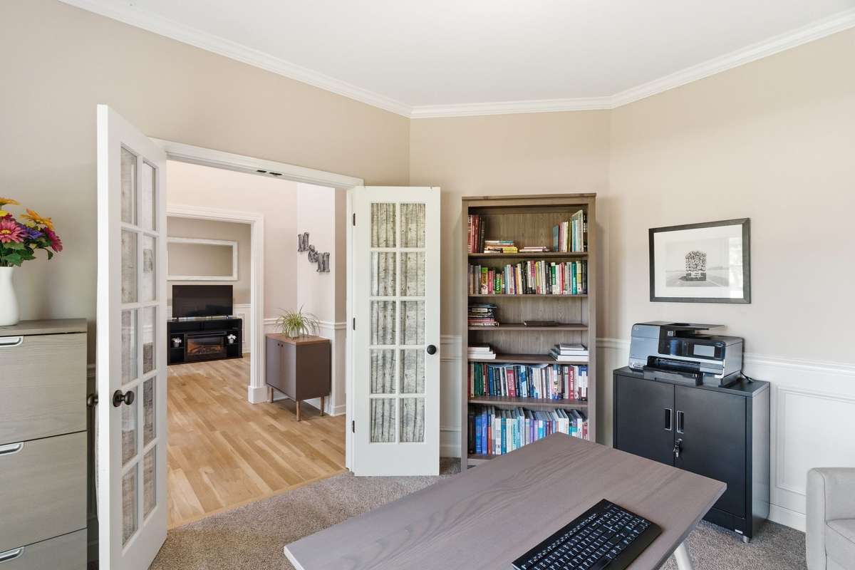 First floor office with double doors & natural light, overlooking the beautiful front yard!
