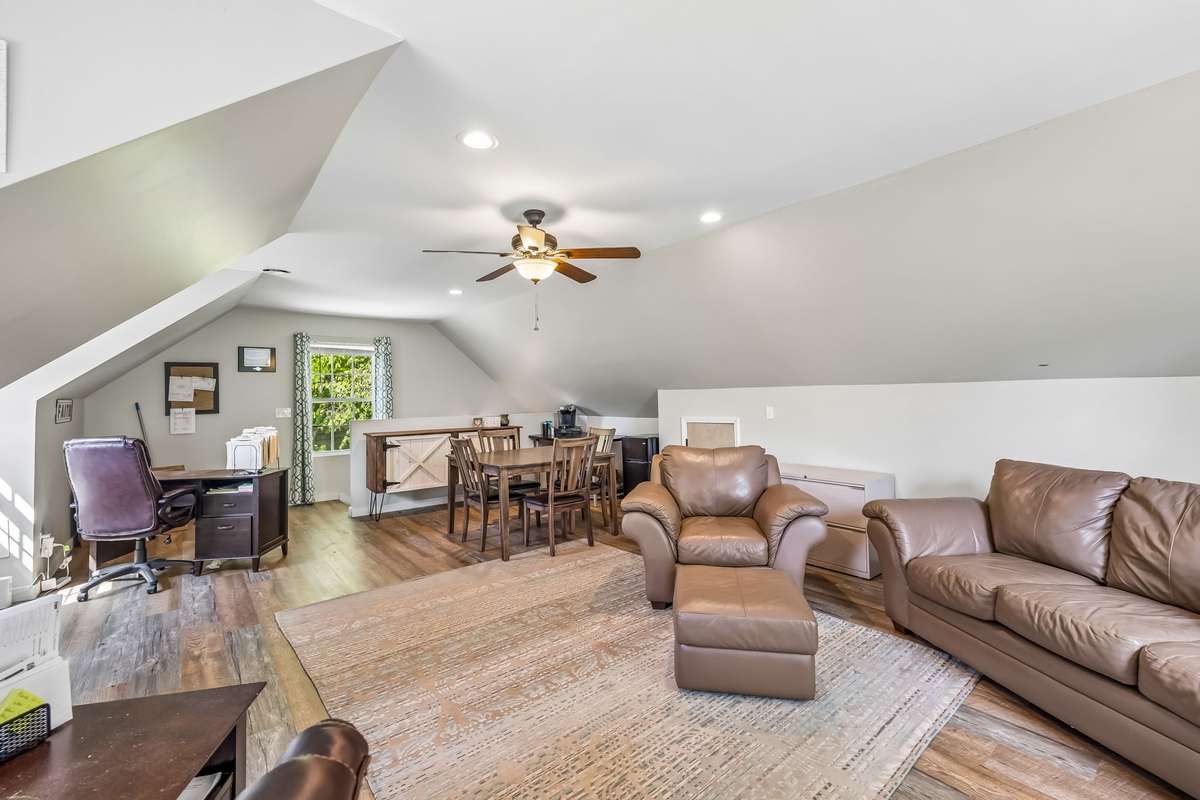 Finished bonus room above the detached garage with vaulted ceilings and recessed lighting, a smart setup for a home office or extra hangout space.