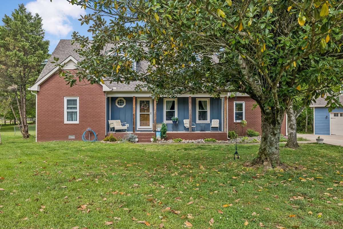 Welcome to 3516 Laurel Court, Murfreesboro, TN. Partial brick home in The Foothills with blue shutters and front porch, set on a level lot with mature trees.