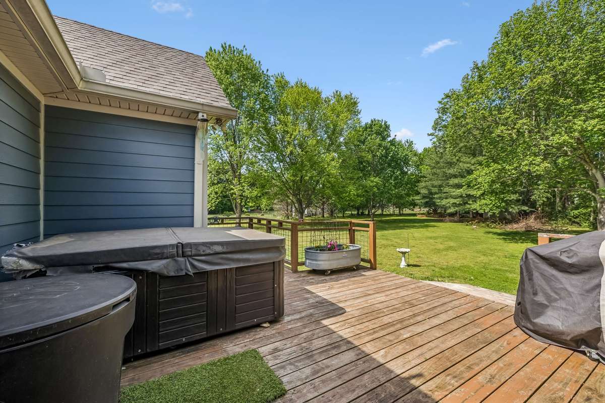The wood deck extends beyond the covered section with room to set up different zones for dining and lounging.