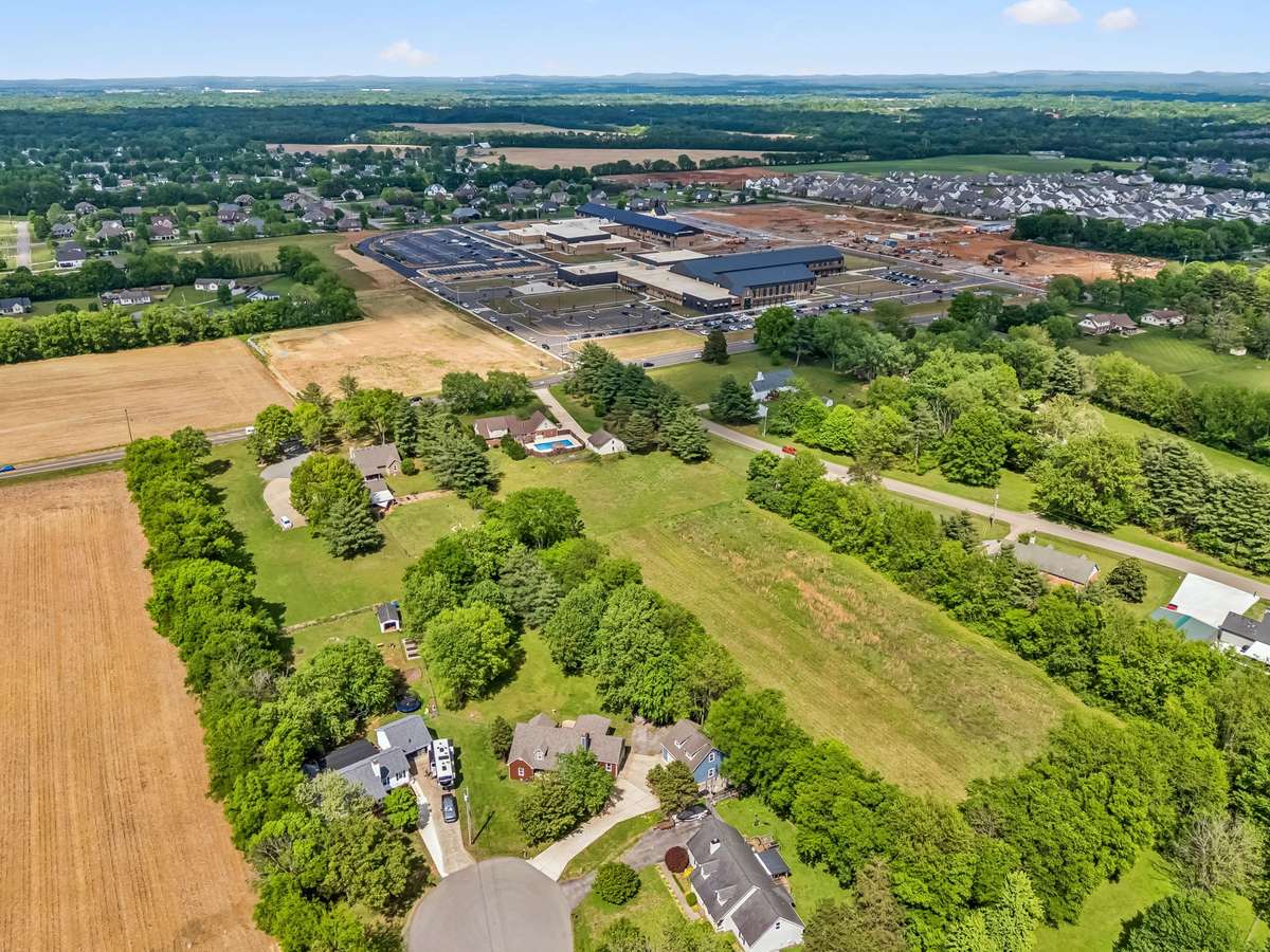 Sprawling private lot bordered by mature trees sits just minutes from new schools and established neighborhoods beyond.