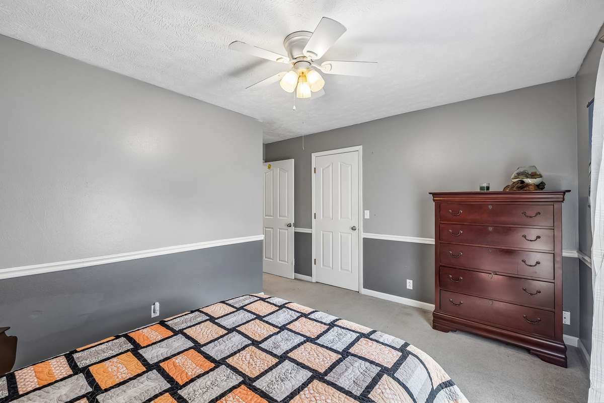 This secondary bedroom has features a large closet and carpet, tucked away from the main living spaces.