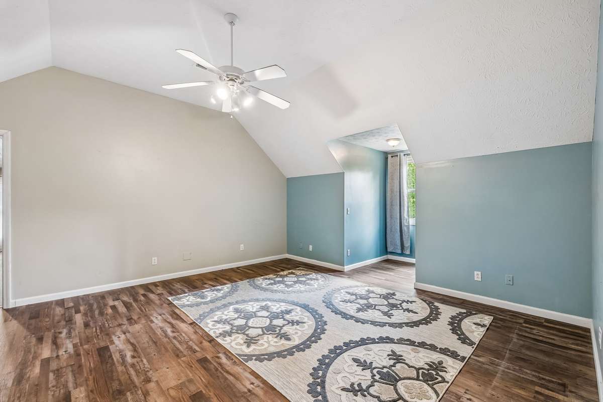 Open-concept feel with the vaulted ceiling and how this flows toward the kitchen area in the back.