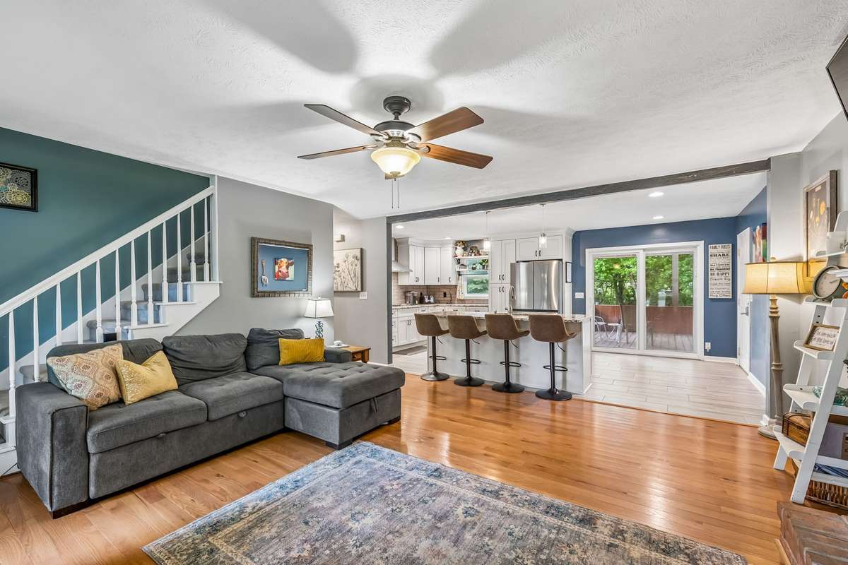 This open layout connects the living area to the kitchen island and stairs, giving you sight lines across most of the main level.