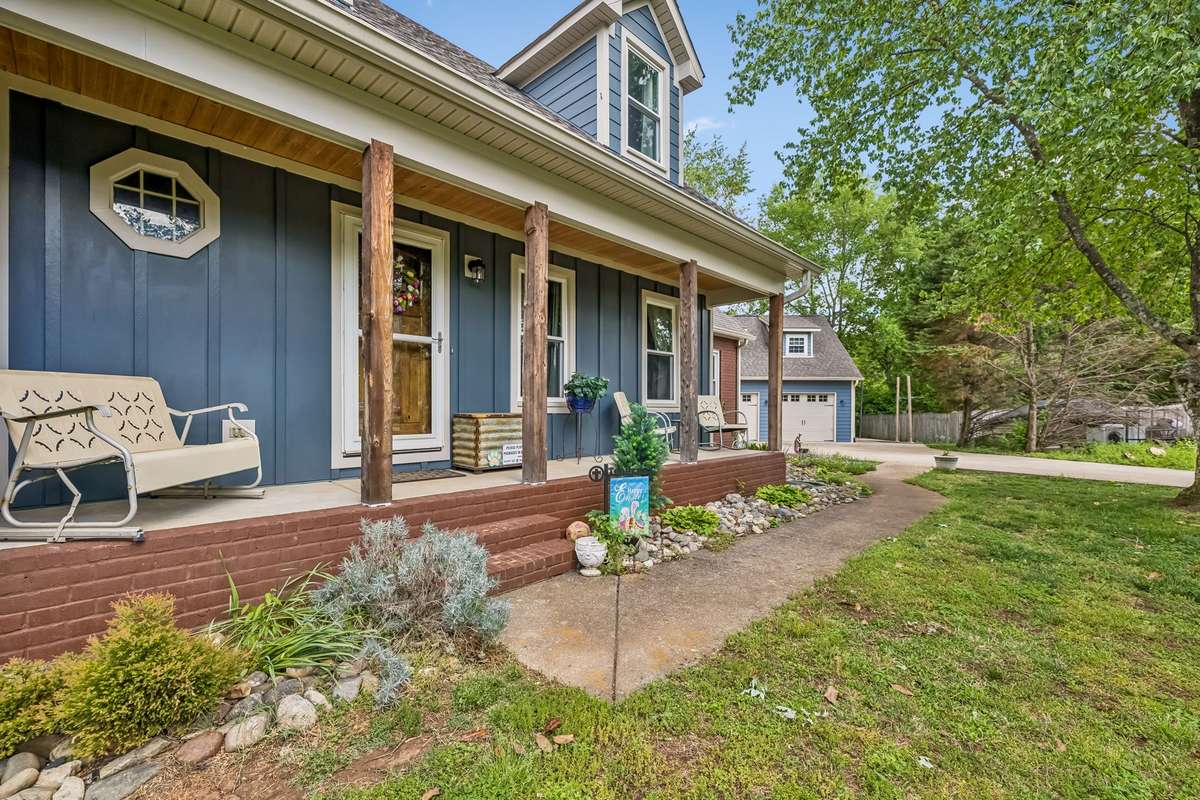 Covered front porch with enough room for a couple of chairs and morning coffee.