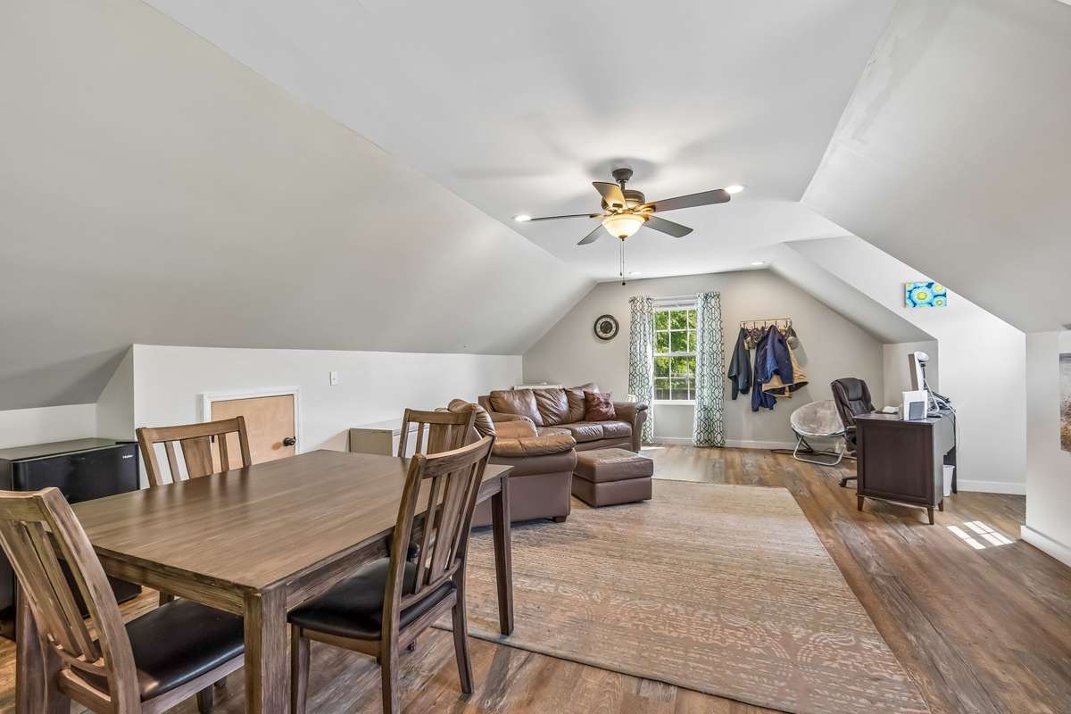 Finished office and living area with vaulted ceilings and natural light from the dormer window above shop