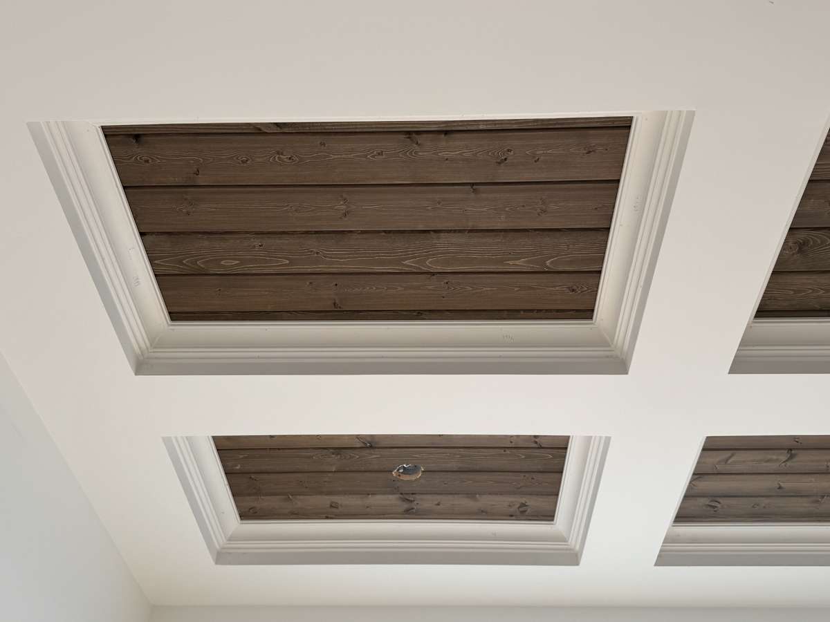 Coffered ceilings are accented with stained tongue and groove.