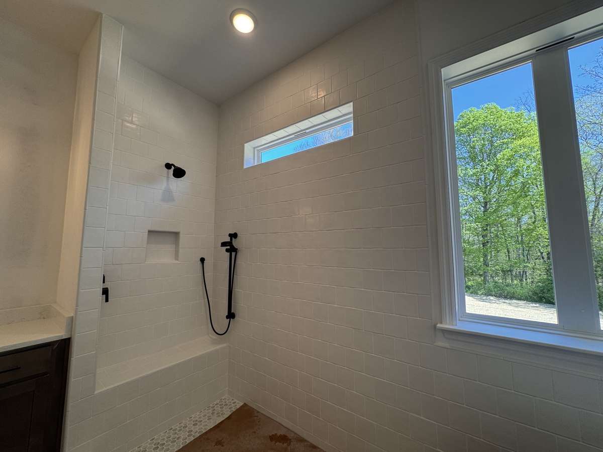 The Primary bath will have a freestanding tub and beautiful shower with seat, niche and handheld faucet.