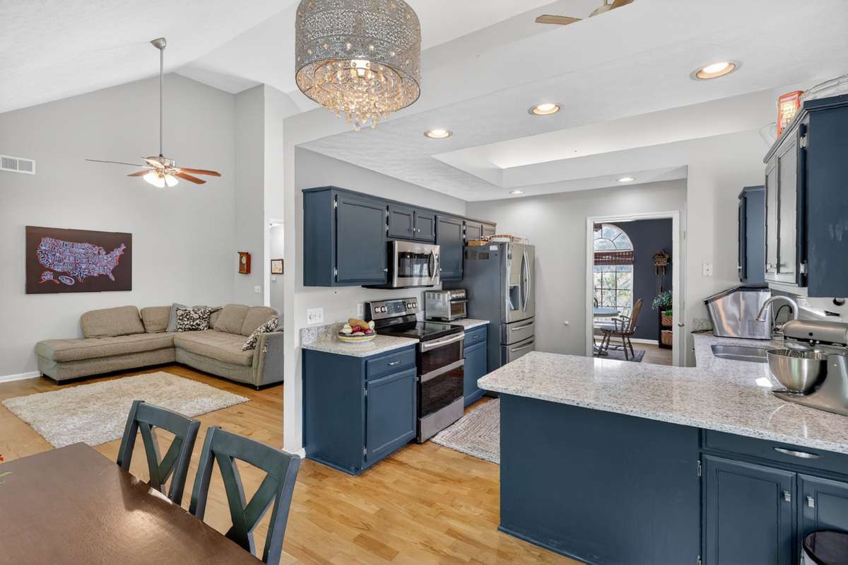 newer solid surface counter tops and stainless appliances help to dress up this large and lovely kitchen!