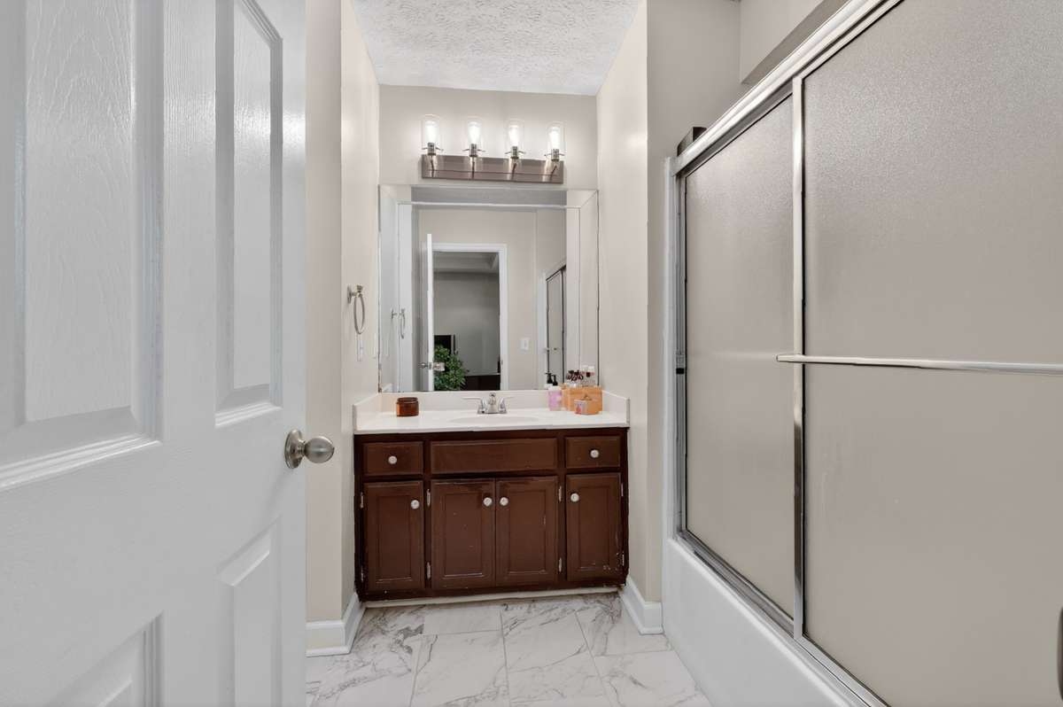 Primary bathroom is ensuite and features a vanity with ample storage and a tub/shower combo