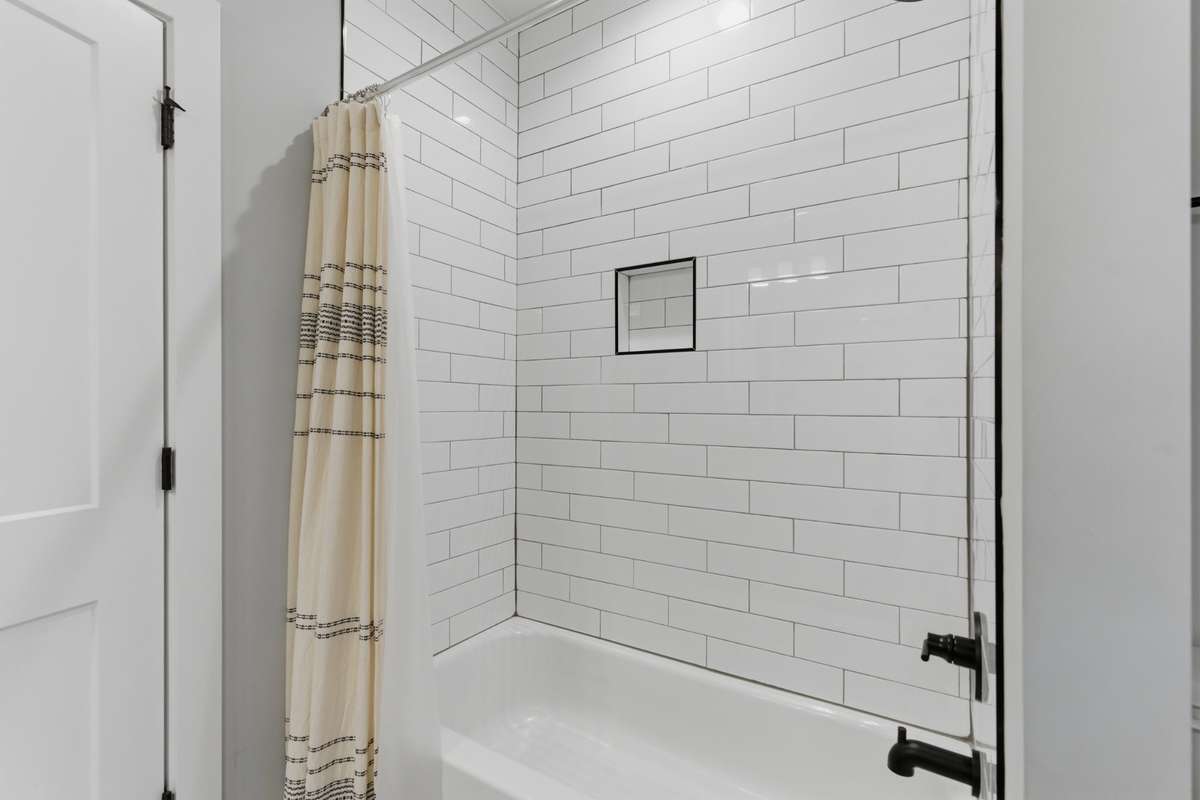 A classic subway tile surround frames a deep bathtub.