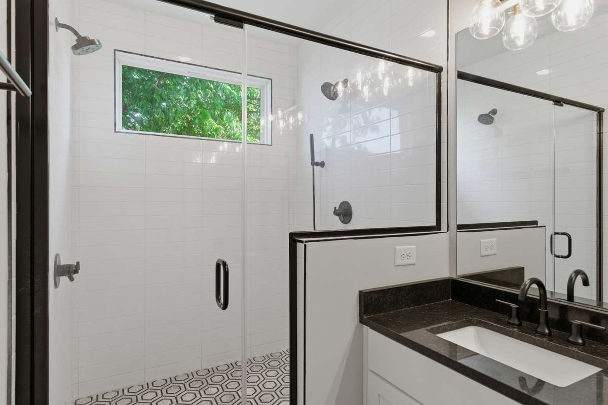 The custom walk-in shower includes designer tile and dual showerheads!