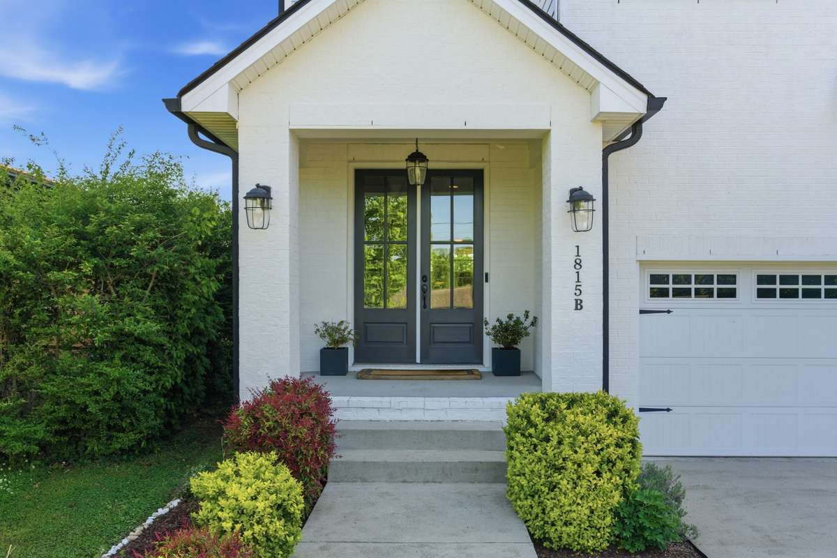 Elegant landscaping leads you to the covered porch.