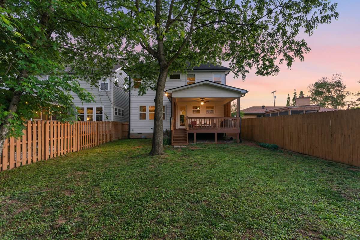 Mature trees offer shade on sunny days! The tall fence makes this yard perfect for pets.