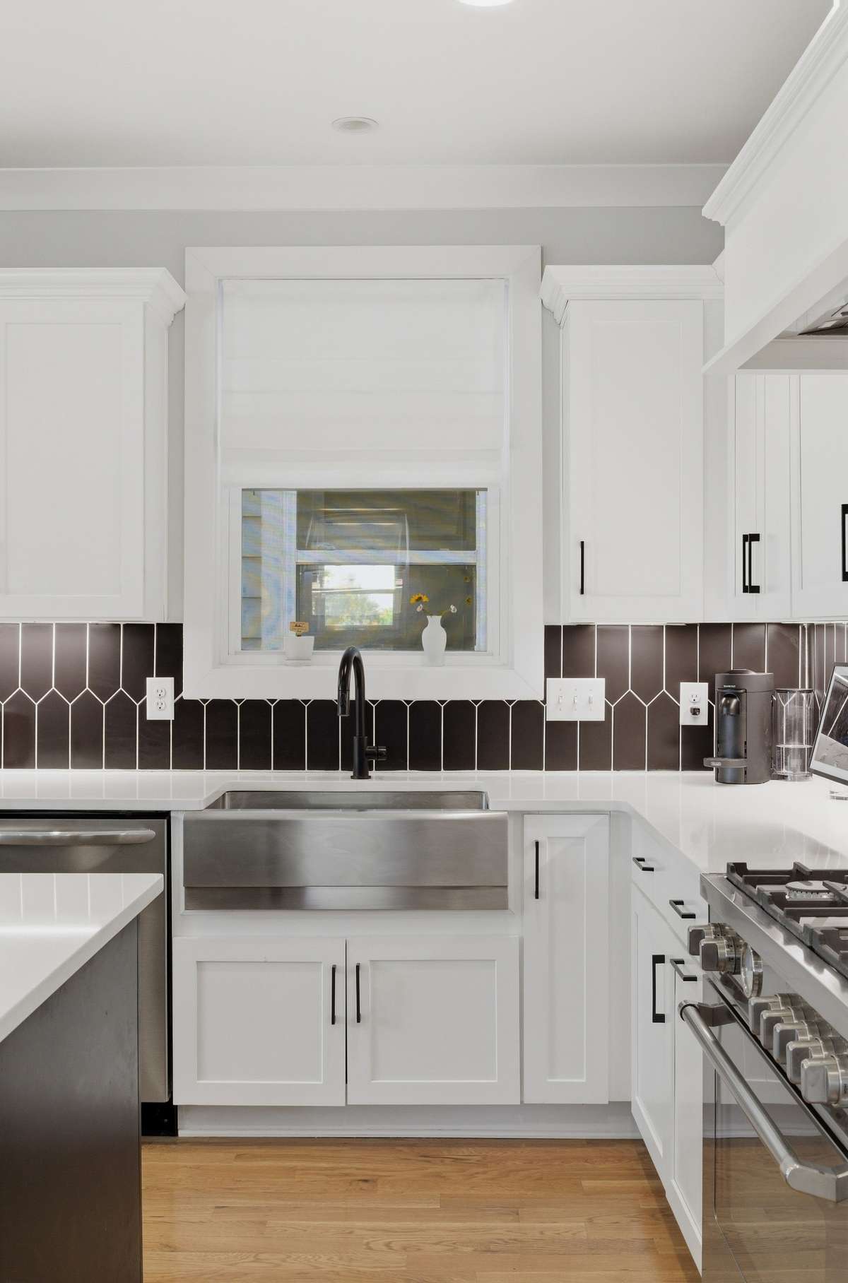 Under-cabinet lighting shows off the chic tile backsplash.