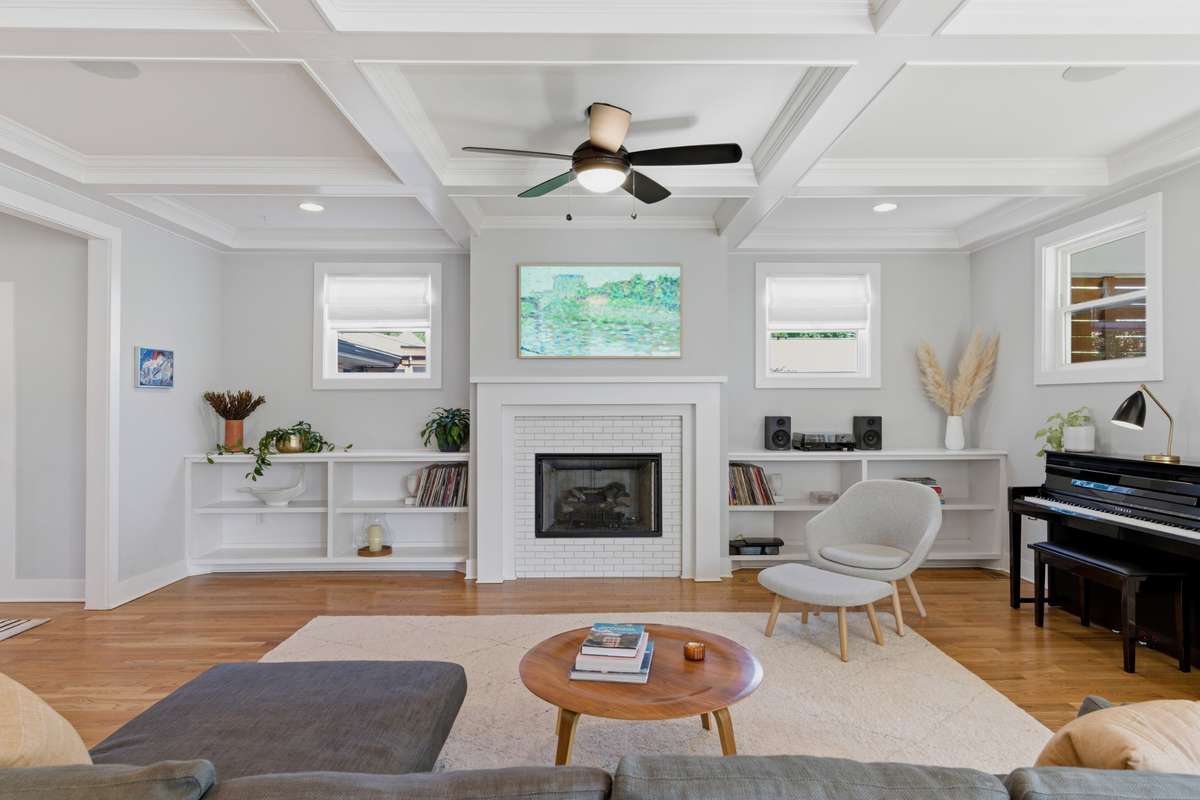 Custom built-ins frame a big gas fireplace.