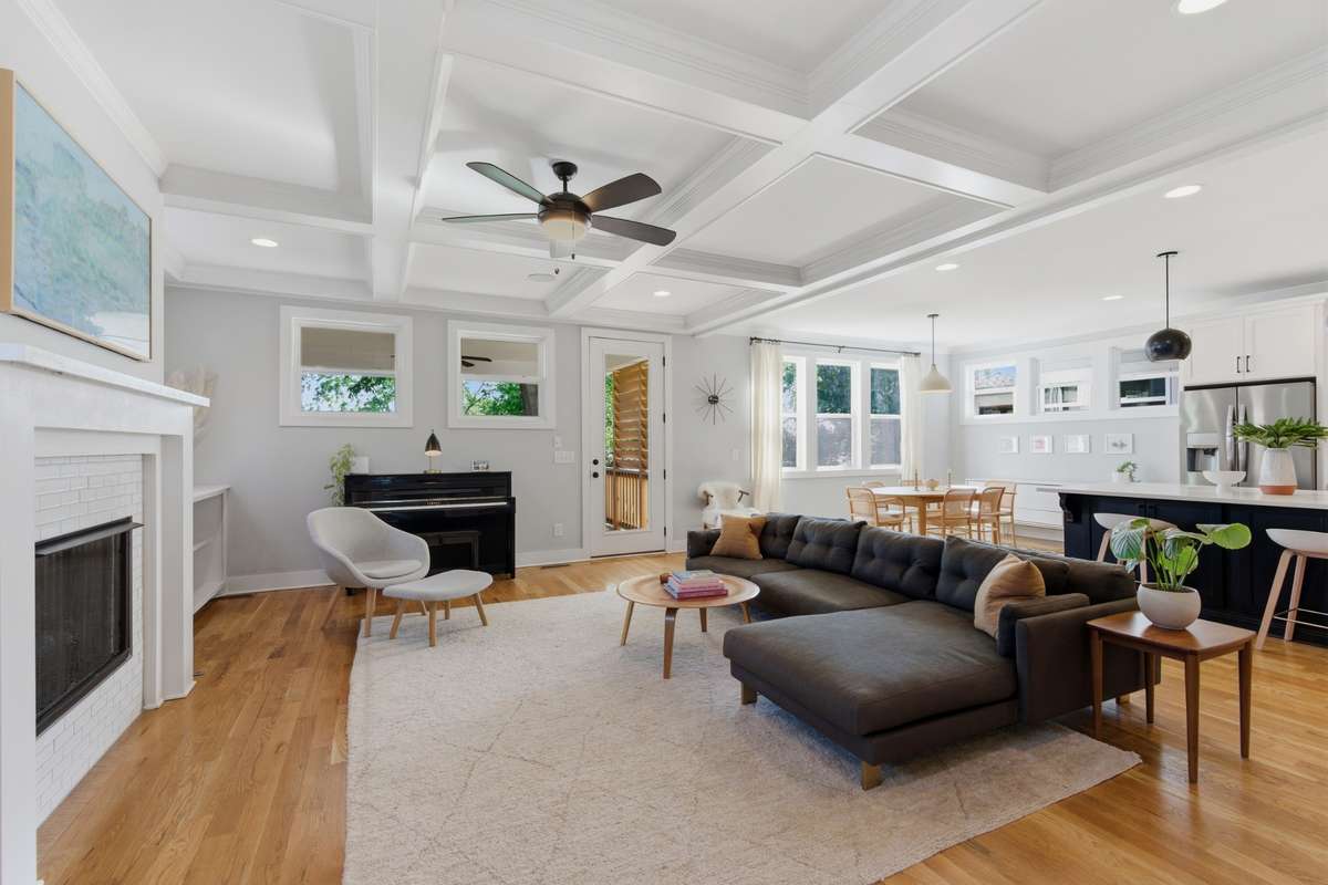 The spacious living room features high coffered ceilings.