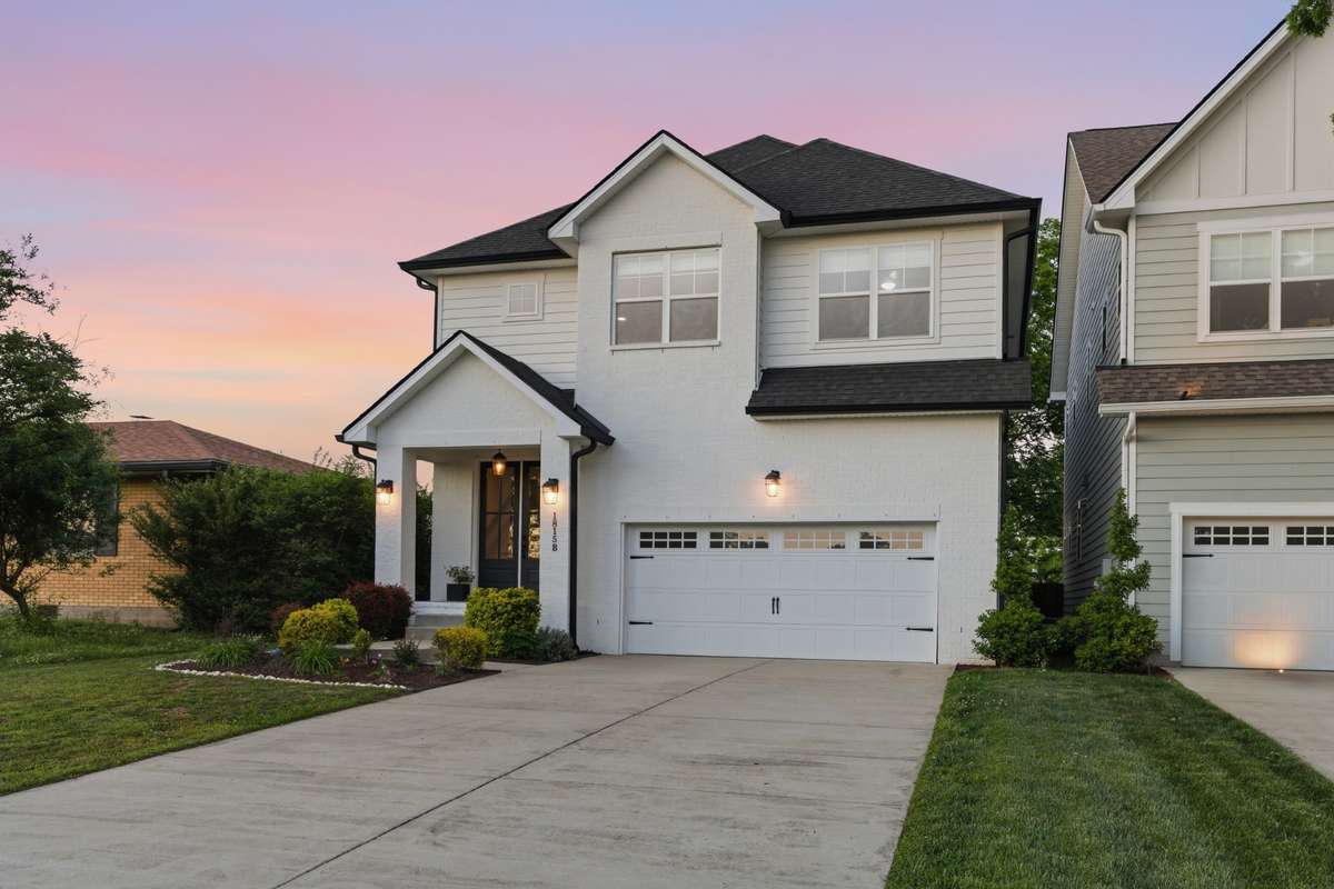 The long driveway and two-car garage offer convenient off-street parking.