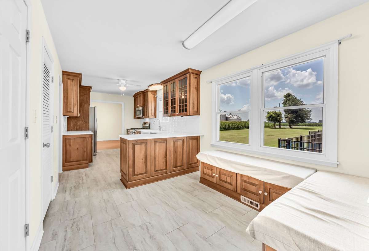 Custom-built cabinets with soft-close drawers and pull-out shelves, quartz countertops, and a gas stove.