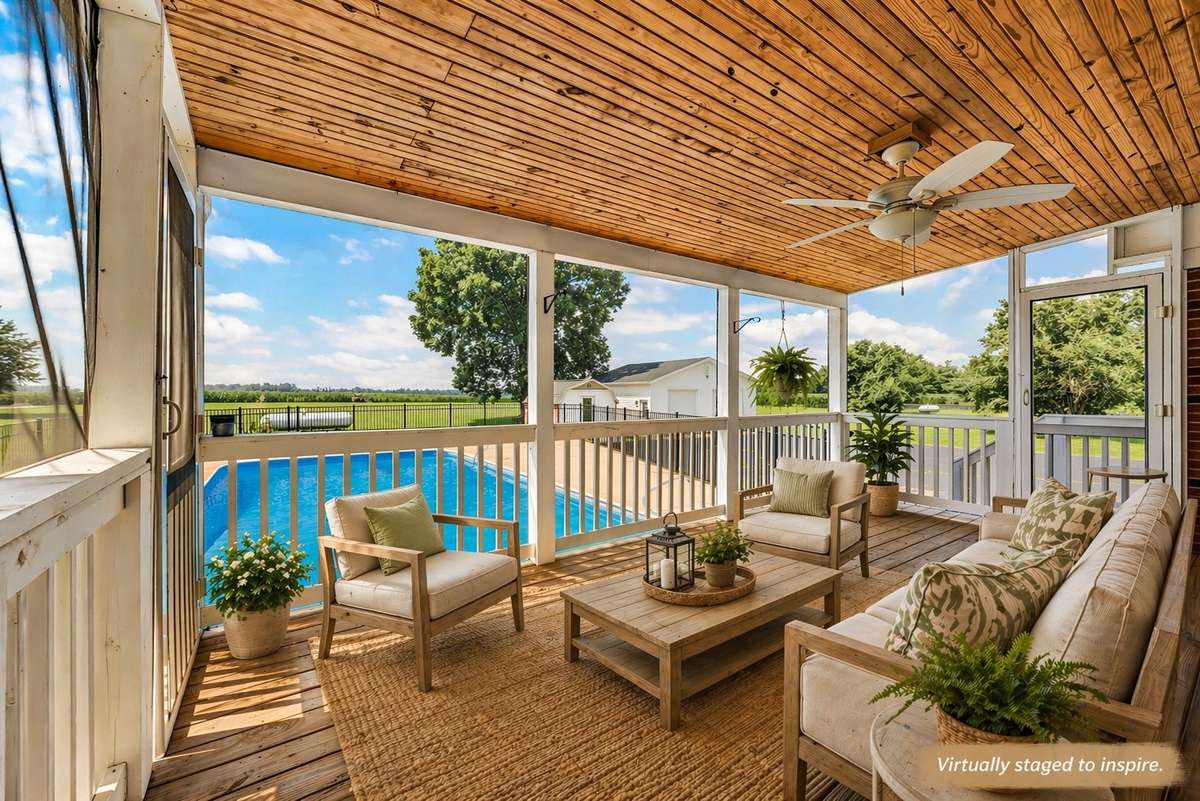 Large screened in back deck overlooks the pool and pristine farmland