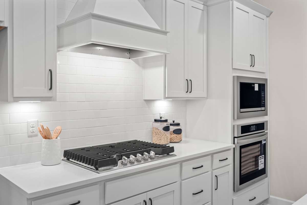 Amazing 5 burner gas cooktop, bricksplash and built in ovens in the wall cabinet