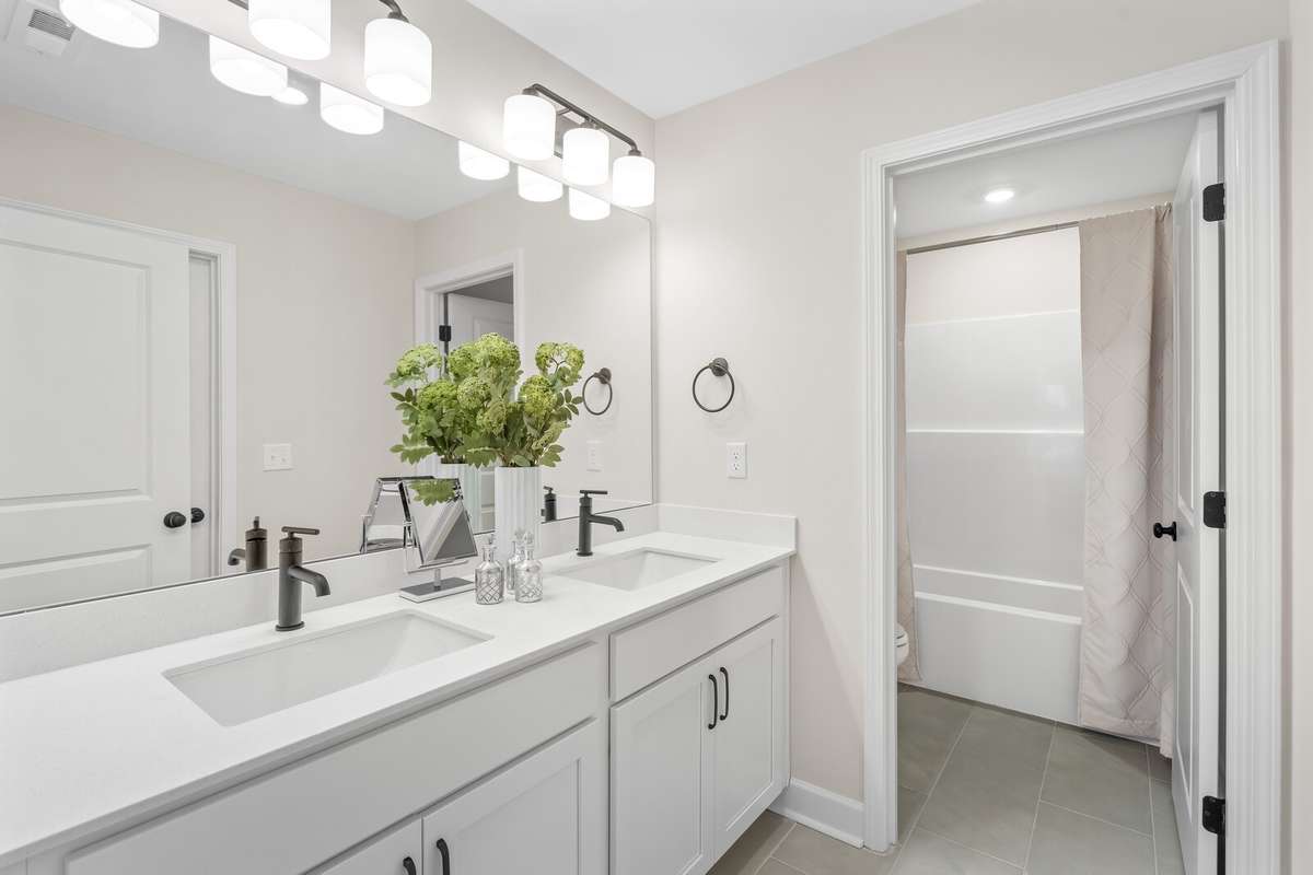 The 2nd bathroom with dual sinks is attached to the 2nd bedroom