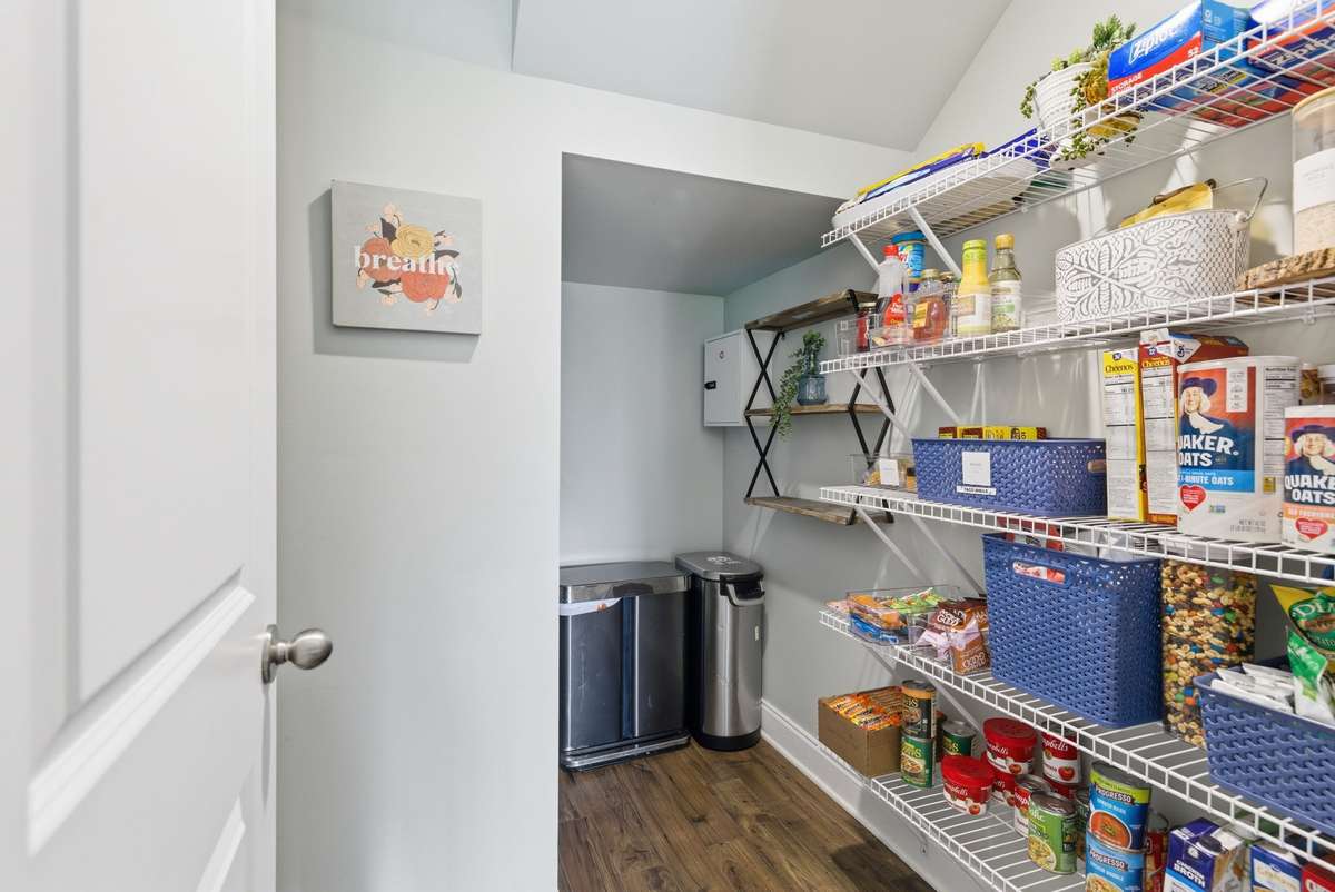Rare, generously sized walk-in pantry offering abundant storage and easy organization for essentials