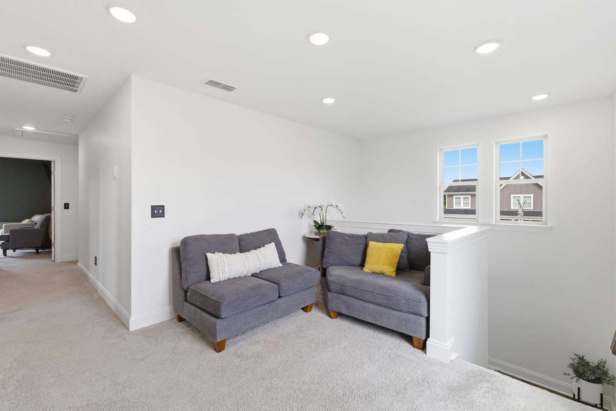 Versatile loft area at the top of the stairs—ideal for a second living space, office, or flex area
