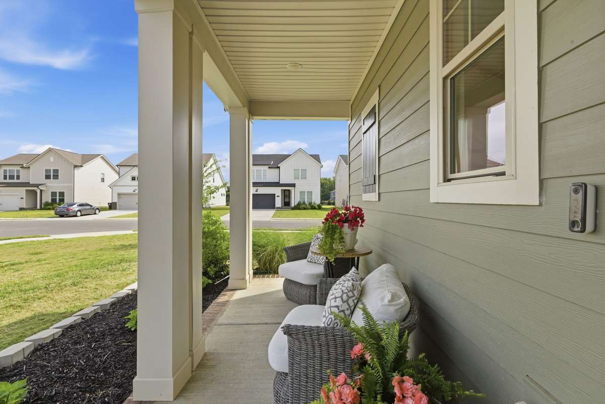 Covered front porch welcomes both guests and homeowners with simple charm