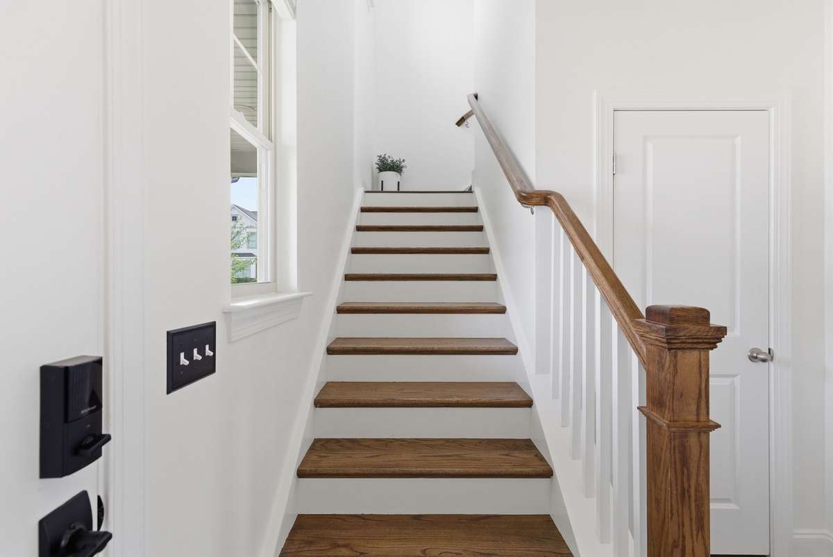 Hardwood staircase creates a grand and welcoming entrance