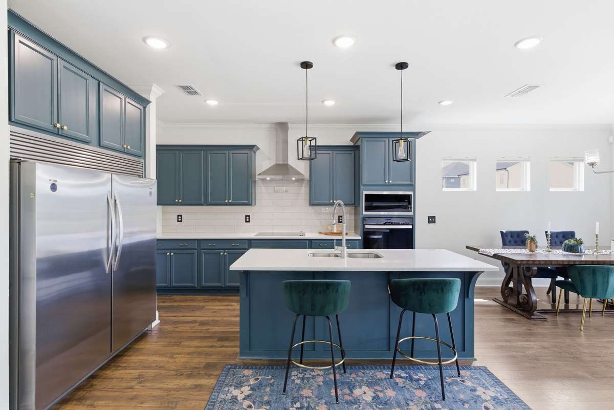 Oversized chef’s refrigerator anchors the kitchen with impressive scale, offering exceptional storage and everyday functionality