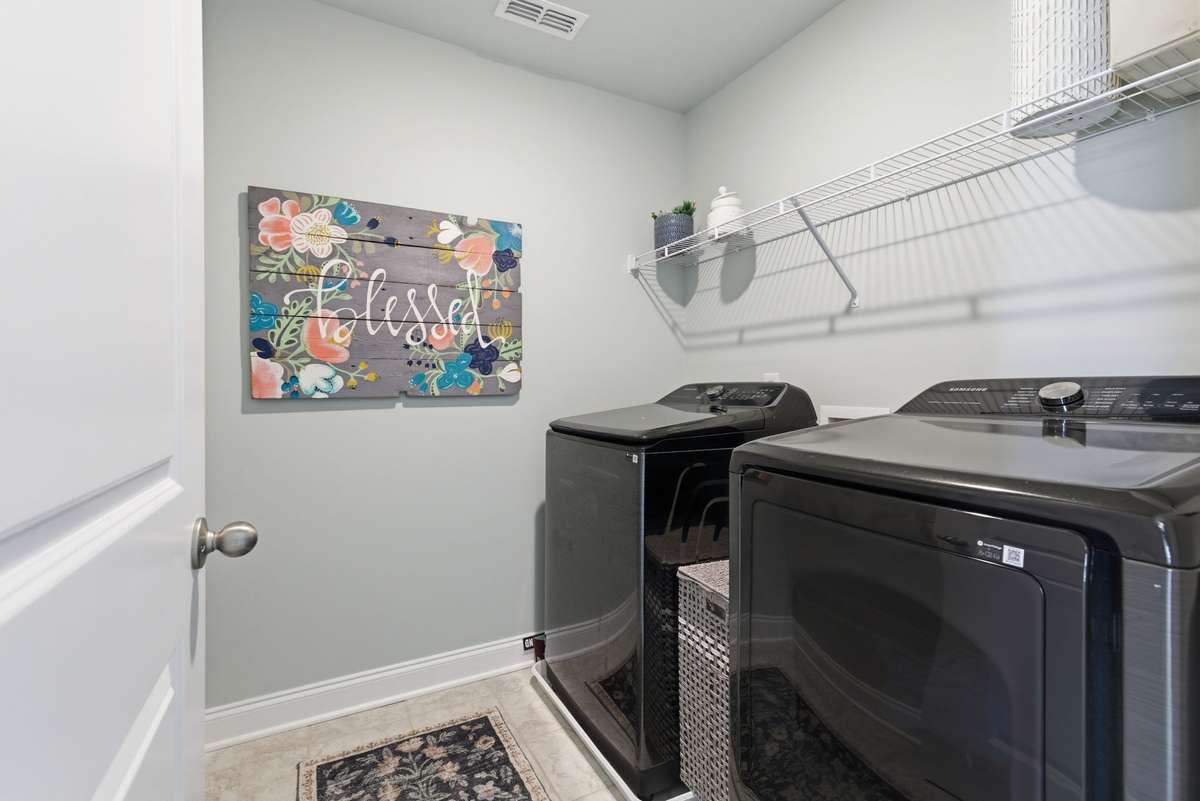 Upstairs laundry space thoughtfully located between bedrooms for everyday convenience and easy access