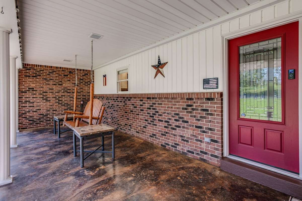 Stained concrete front porch with extra wide porch