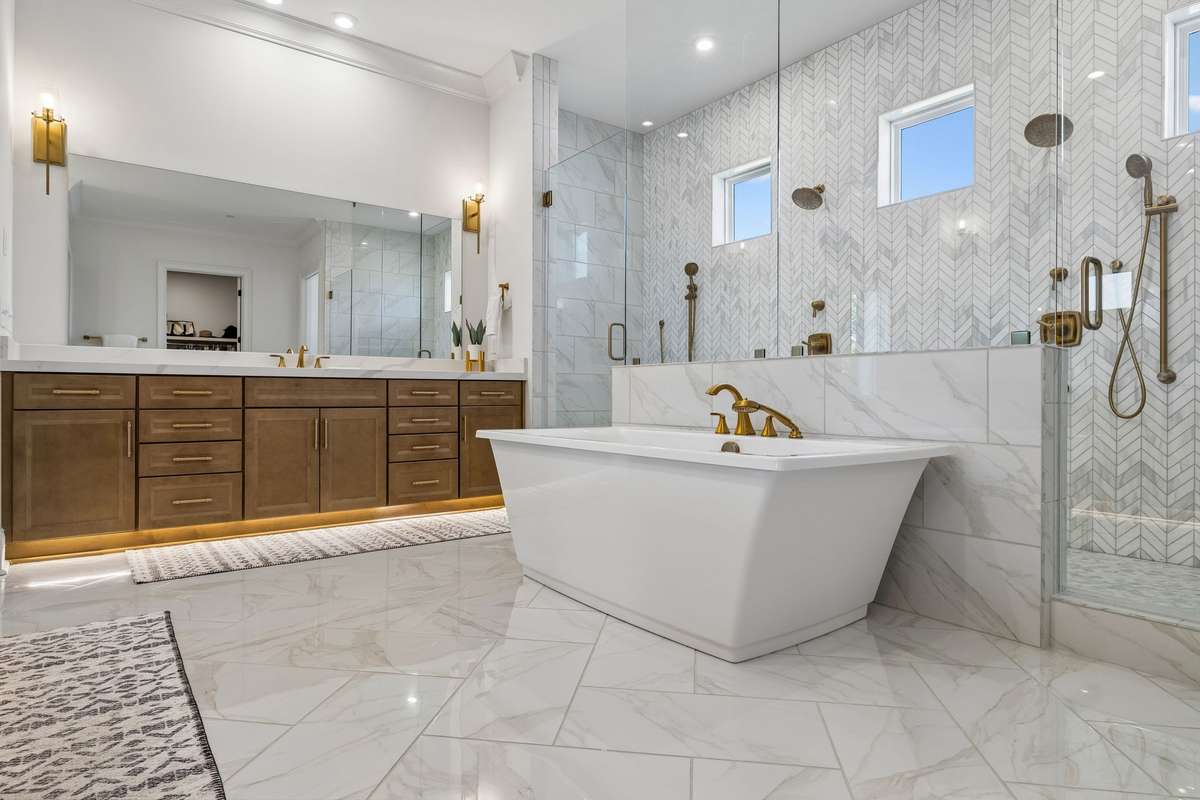 2.5 inch mitered quartz throughout and sconce lighting add to the simple elegance of this space