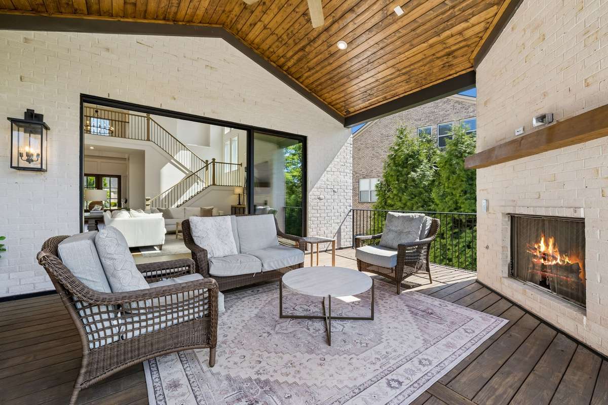 The patio space off the main living room is inviting and private. The gas fireplace and wood ceiling make this a cozy outdoor entertaining space.