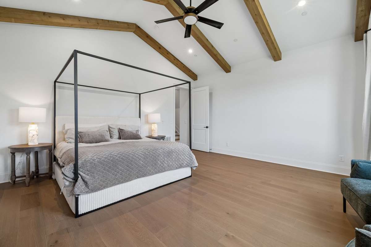 Primary Suite offers stunning views, a vaulted ceiling and exposed beams.