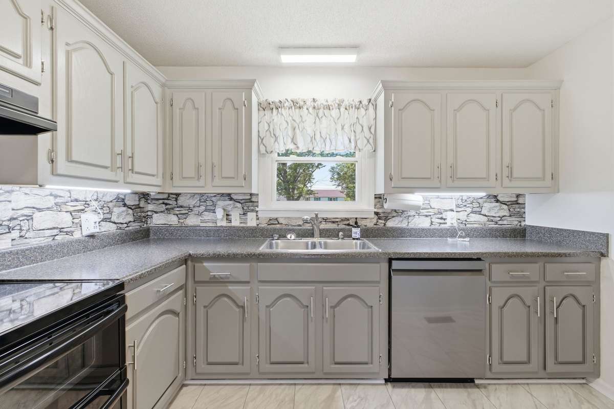 Light-filled kitchen with a window over the sink and generous counter space.
